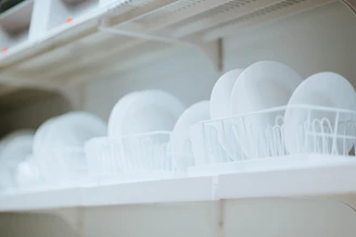 Stacks of neatly packed plastic plates ready for shipment in a spacious, clean warehouse.