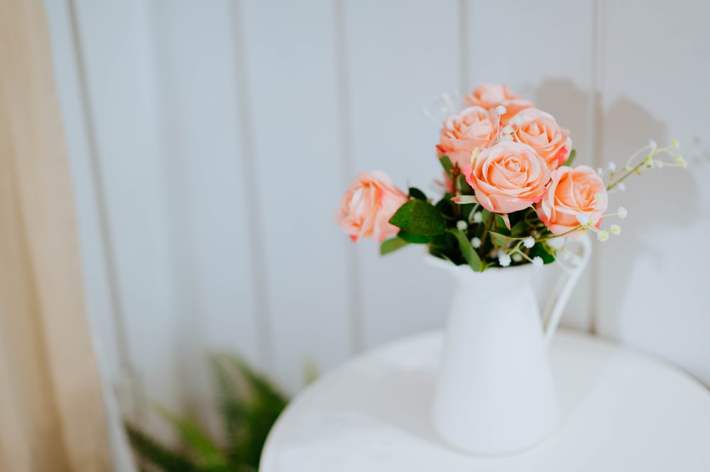 pink flowers in white ceramic vase