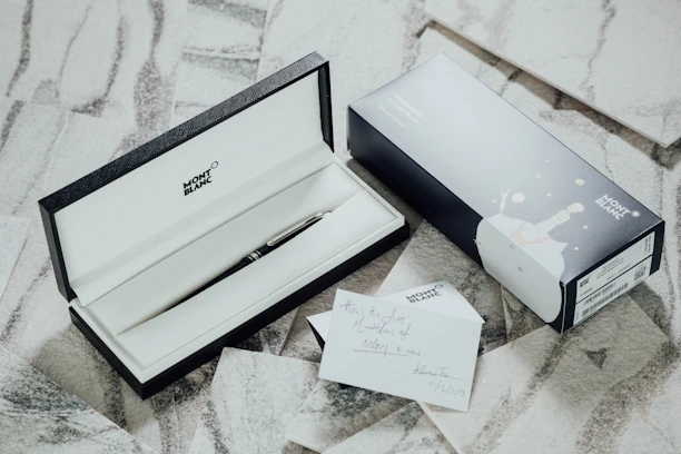 A neatly arranged set of premium corporate gift boxes featuring engraved pens and leather accessories.