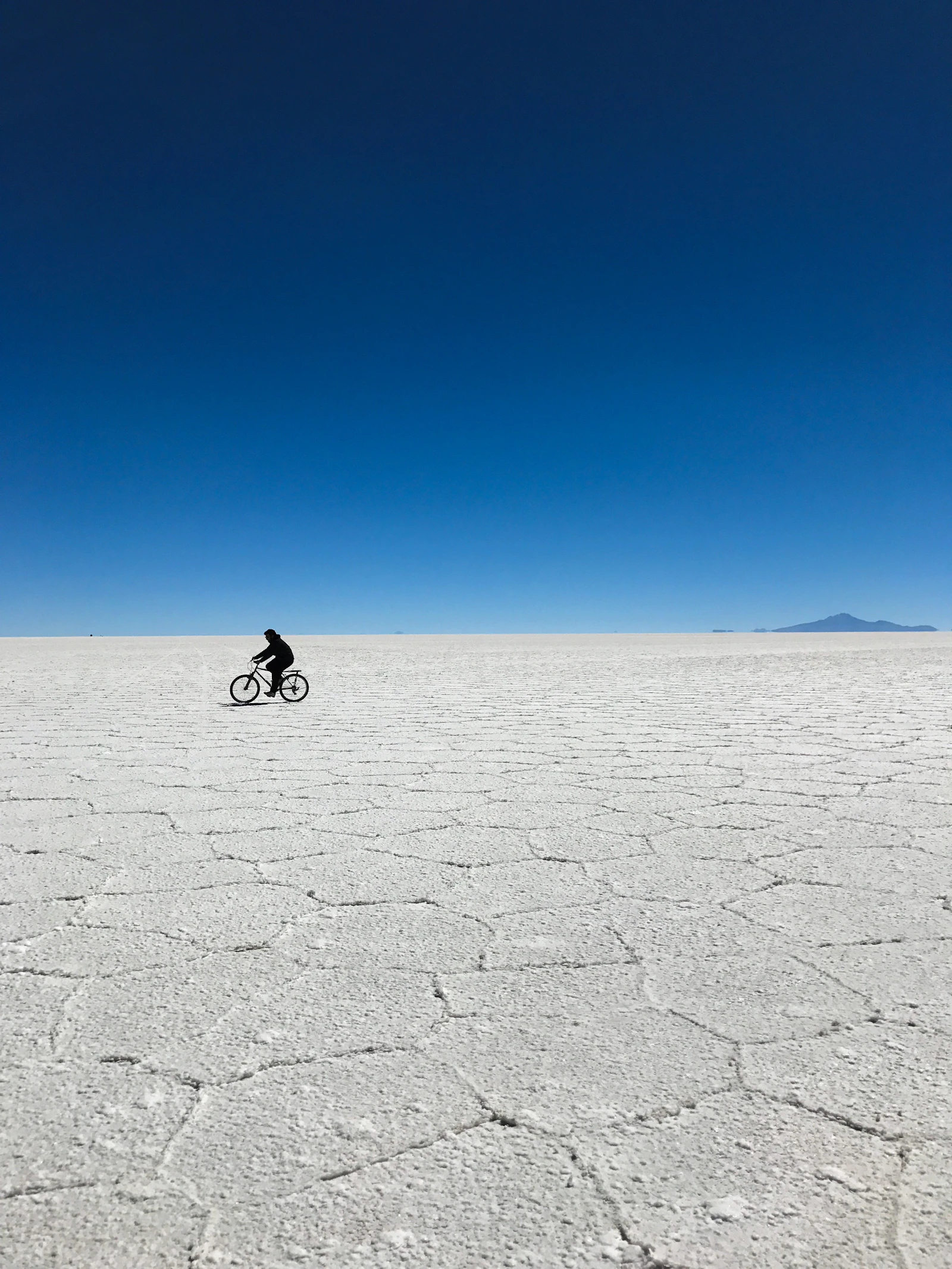 A cyclist crossing the Salar de Uyuni