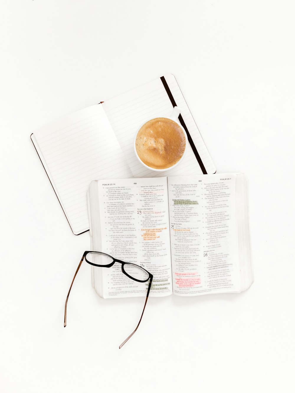 eyeglasses with black frames on top of white book