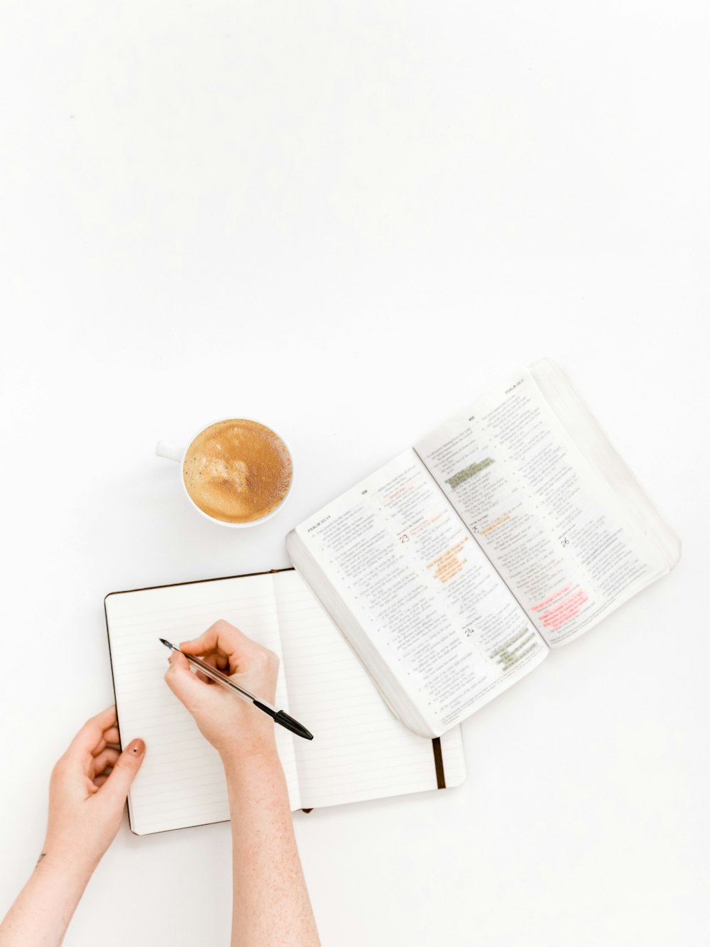 person writing on notebook