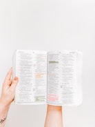 Close-up of hands highlighting text on a dyslexia-friendly workbook.