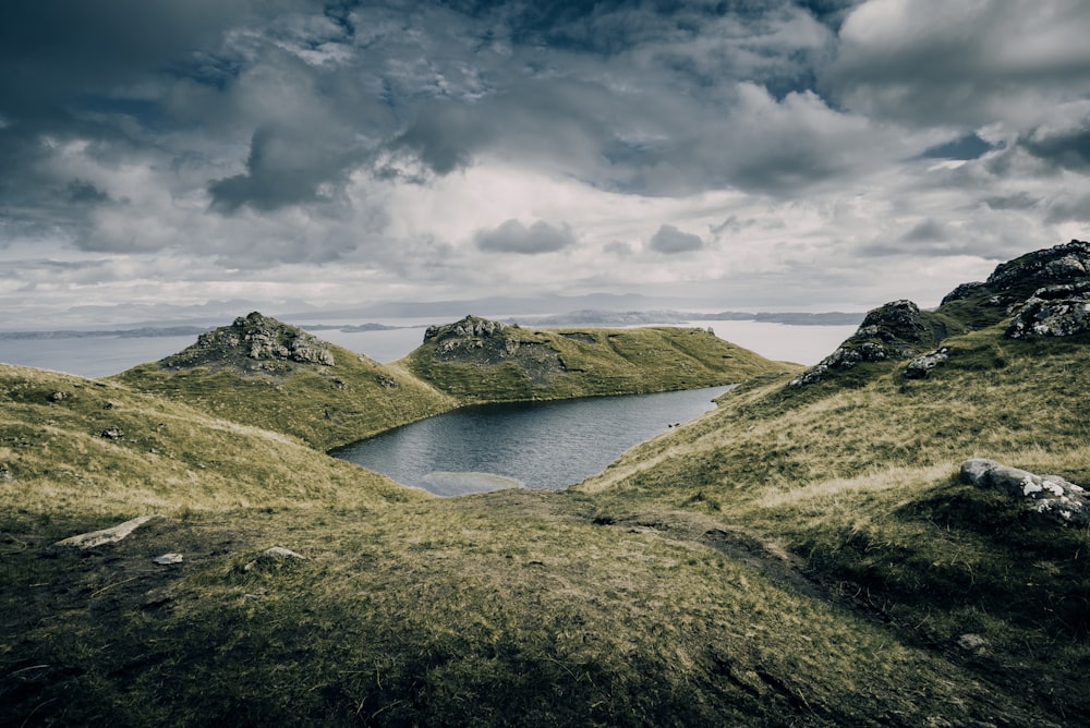 aerial photo of mountains under cloudy sky