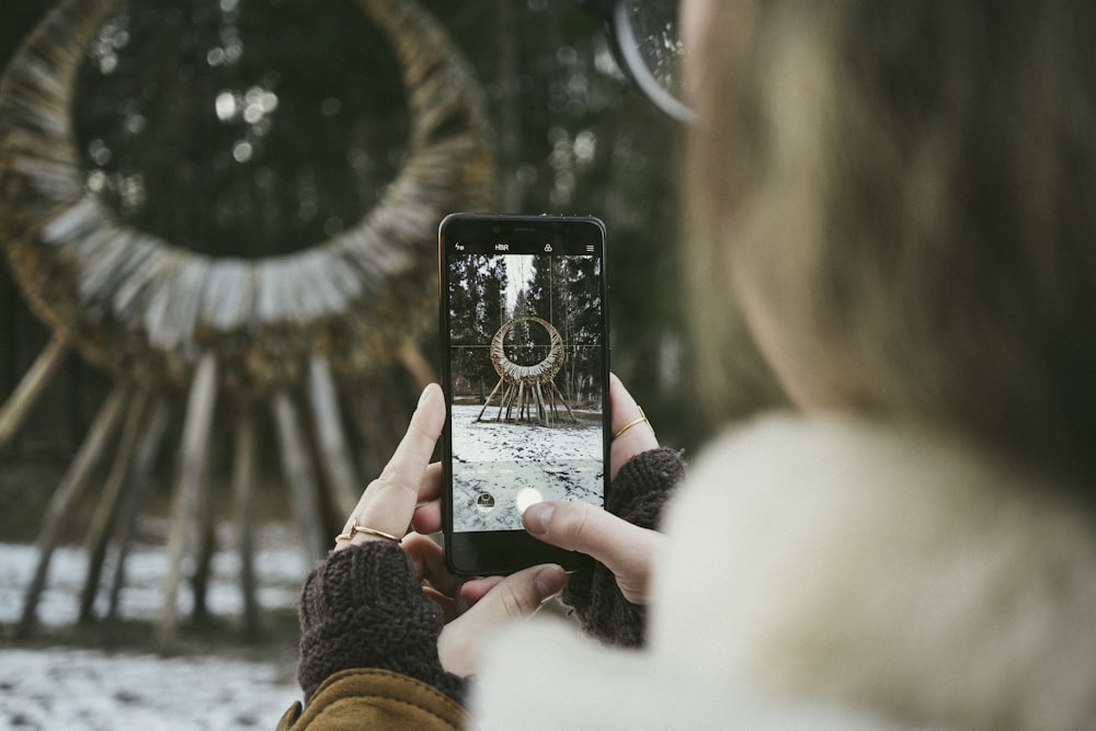 macroshot photography of person holding phone