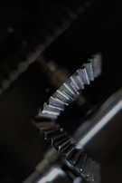 Metal gear wheels in various sizes displayed against a neutral gray background.