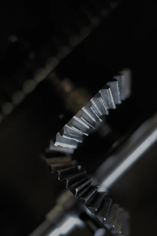 Close-up of a finely machined spur gear reflecting light on its polished teeth.