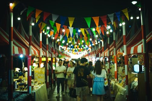 Couples exploring the vibrant night markets of Thailand, surrounded by colorful lights and aromas.