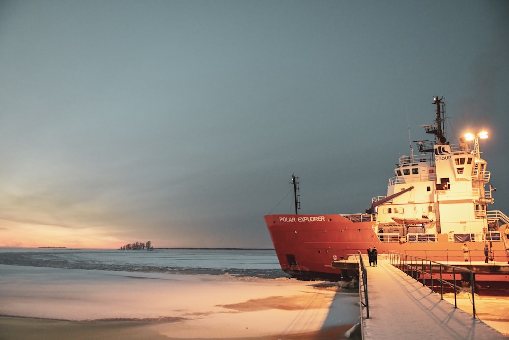 red and white cruise ship near seashore