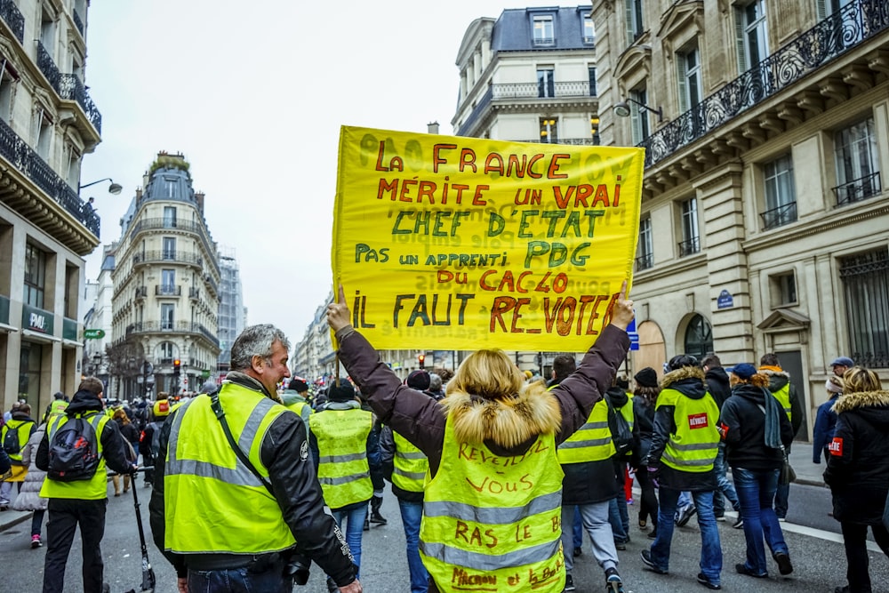 people wearing safety vest doing parade on road