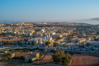 A sprawling industrial park with neatly divided plots under a clear blue sky