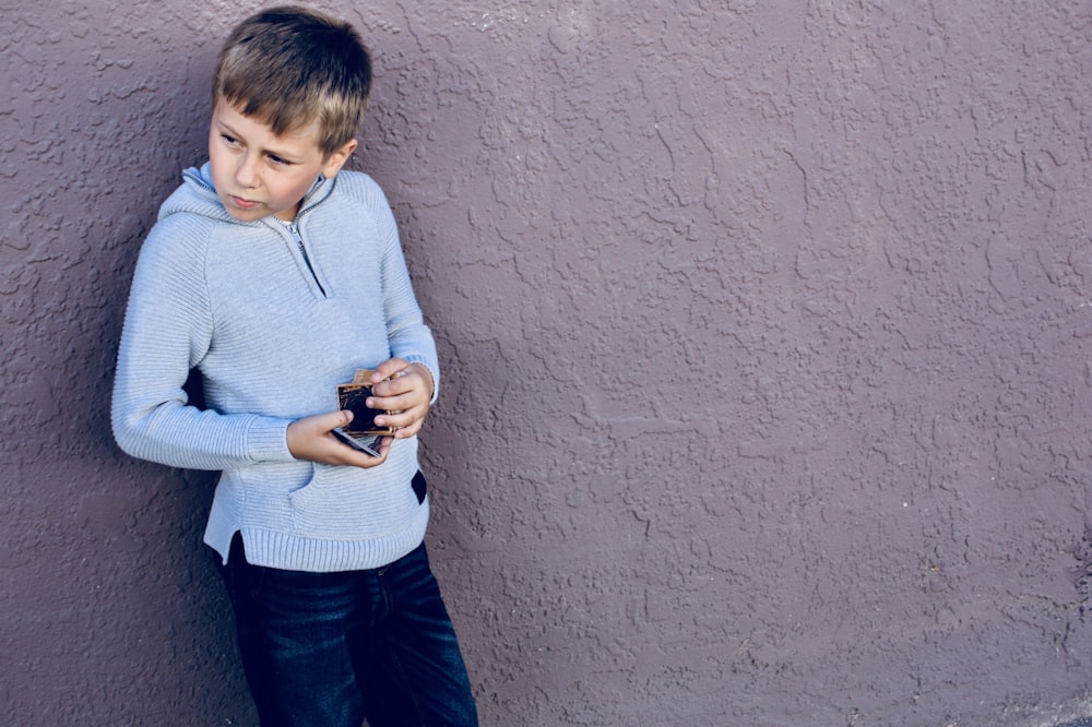 boy wearing blue half-zip jacket