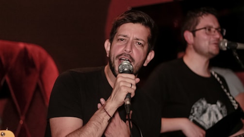 An artist performing live with a microphone in hand