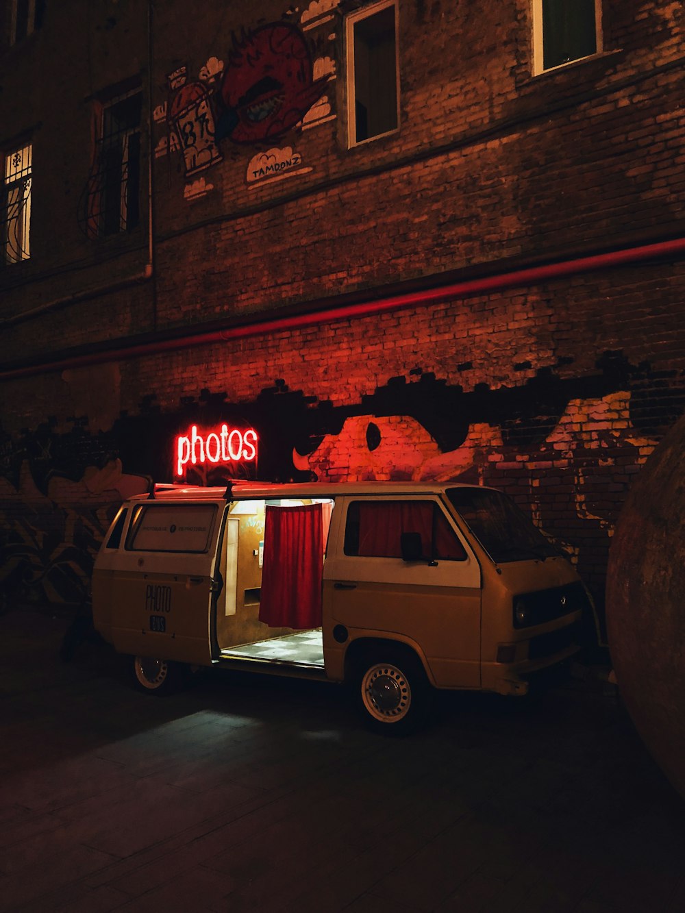 van parking beside wall at night-time