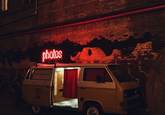 van parking beside wall at night-time
