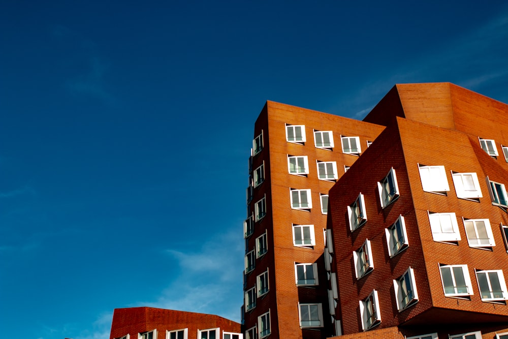 mid-rise brown building under blue sky during daytime