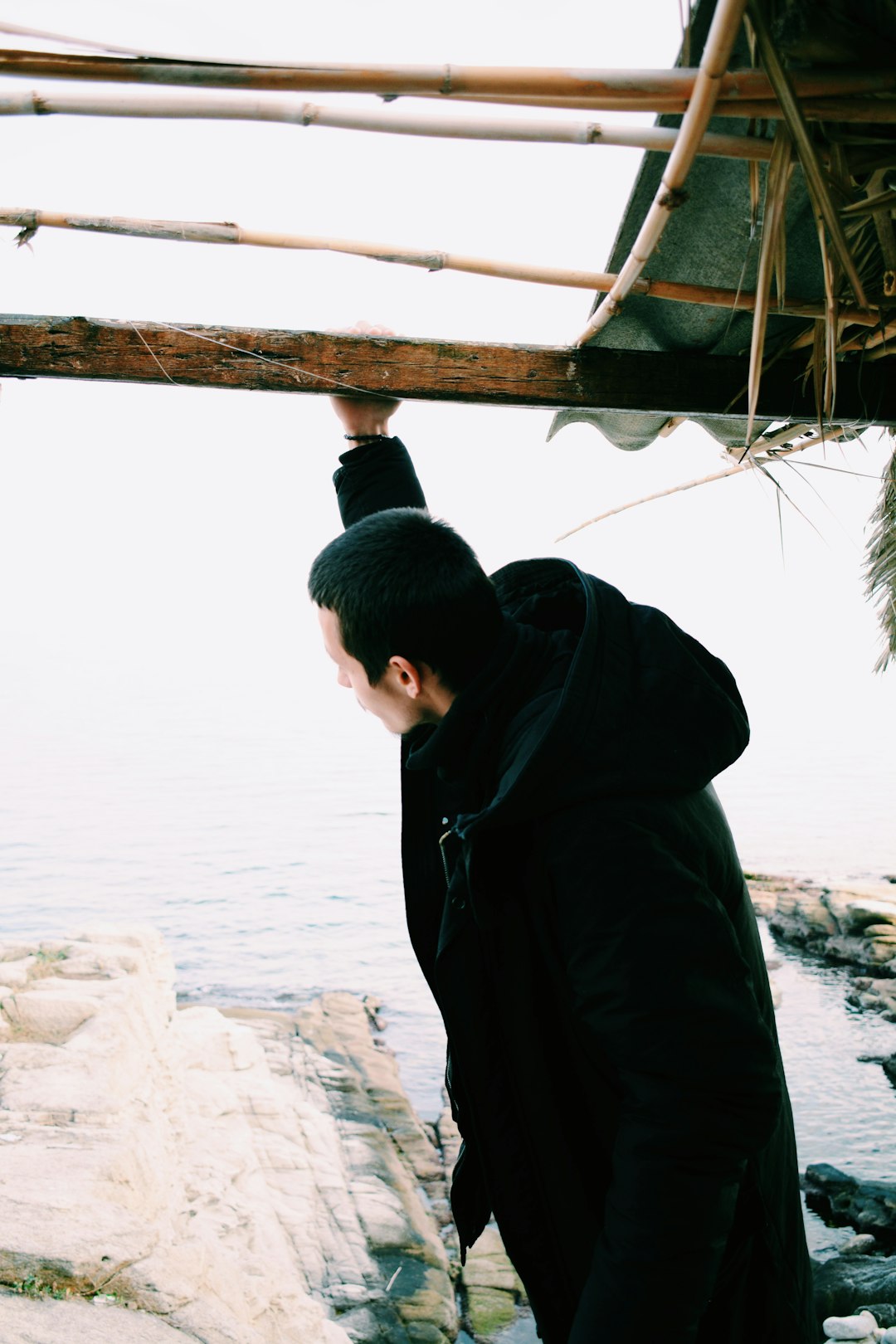 man wearing black hooded jacket during daytime