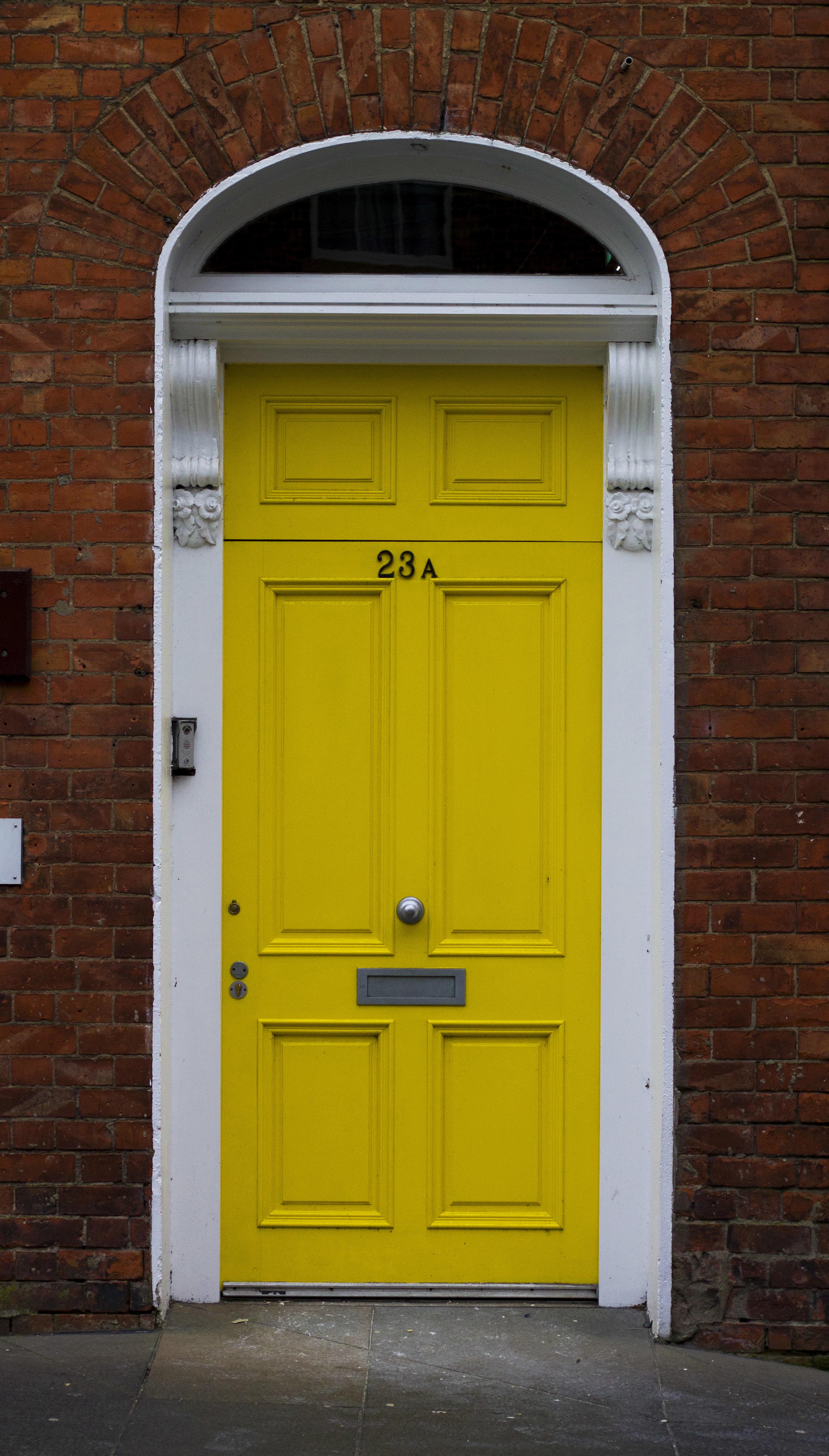 Yellow wooden door closed in its frame