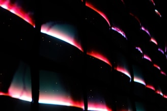 Futuristic 3D holographic stickers floating above a softly glowing pink surface.