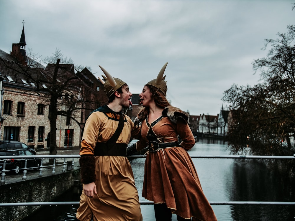 man and woman wearing brown costume