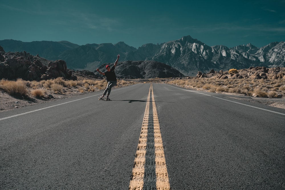 person standing on gray roadway