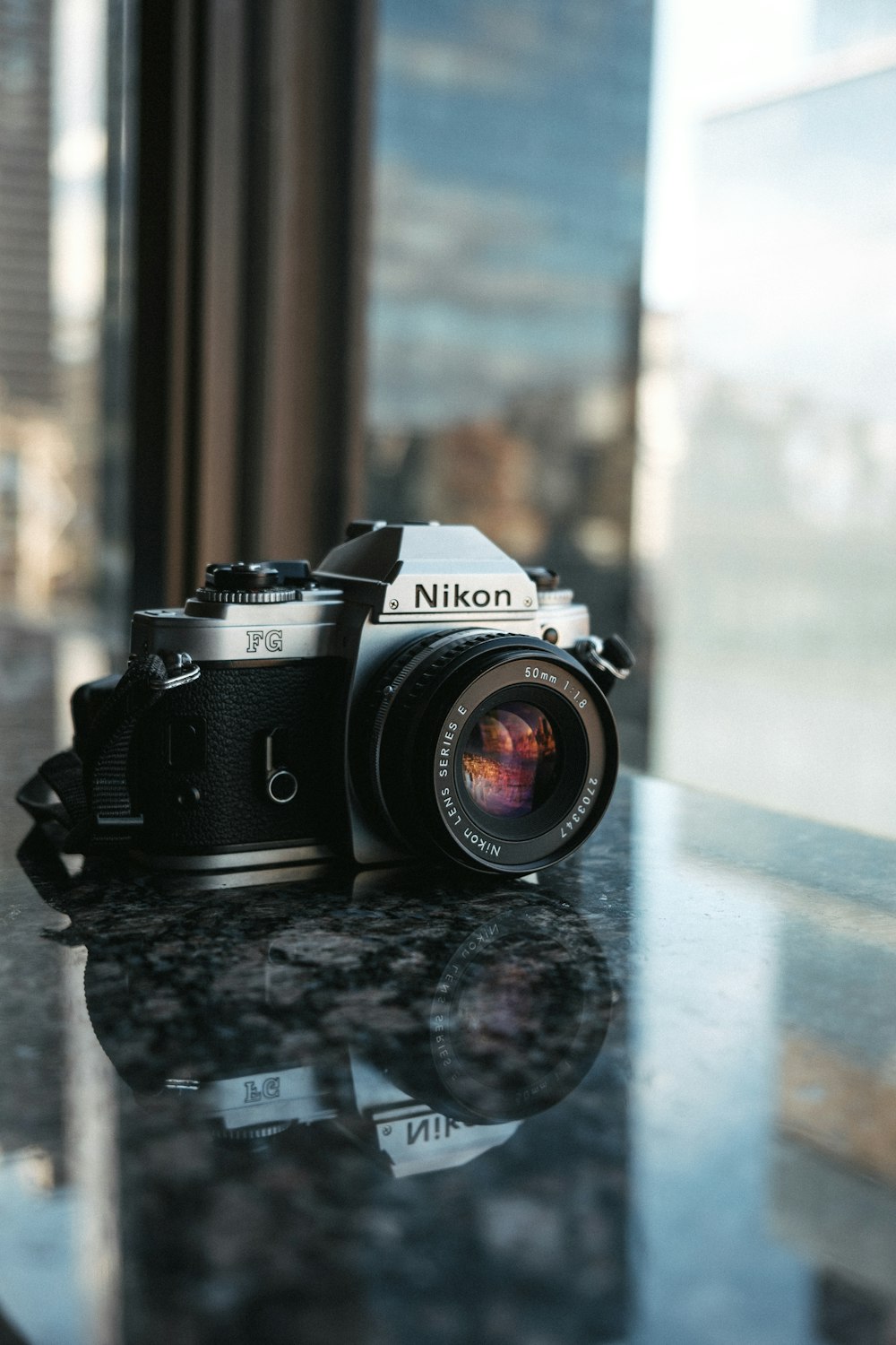 shallow focus photo of black and gray Nikon SLR camera