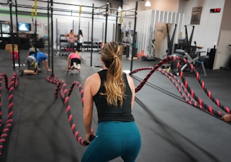 woman in black top pulling rope