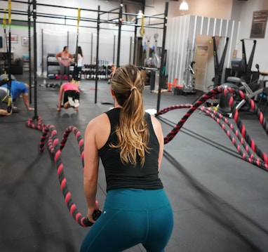 woman in black top pulling rope