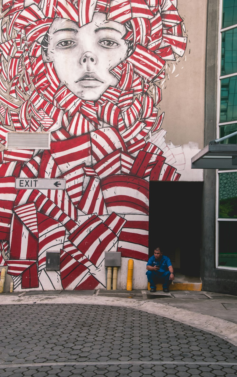 person sitting near wall art