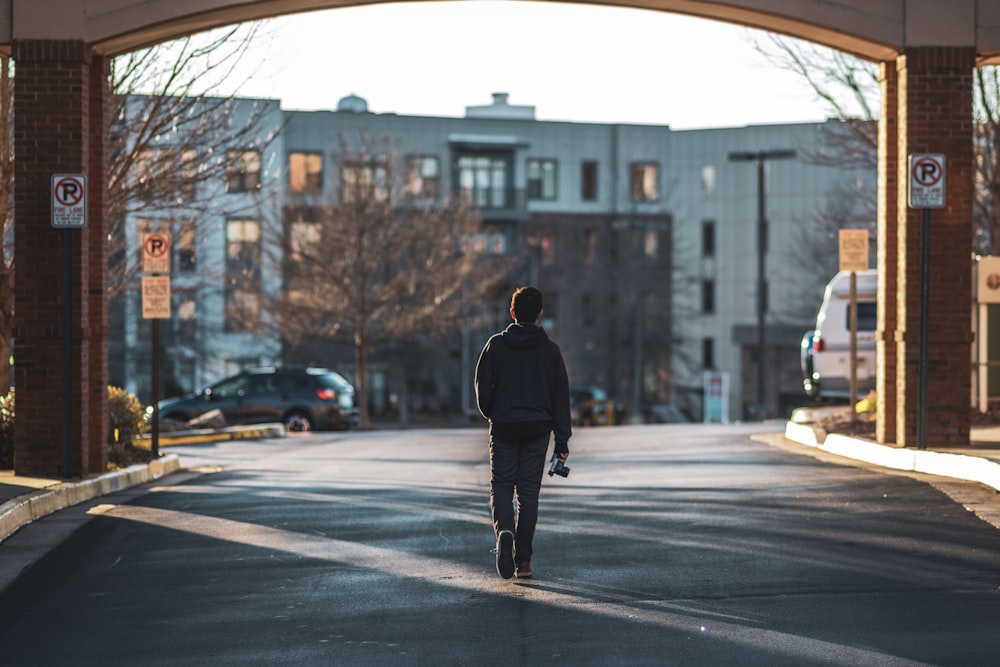 man walking on street near buildings