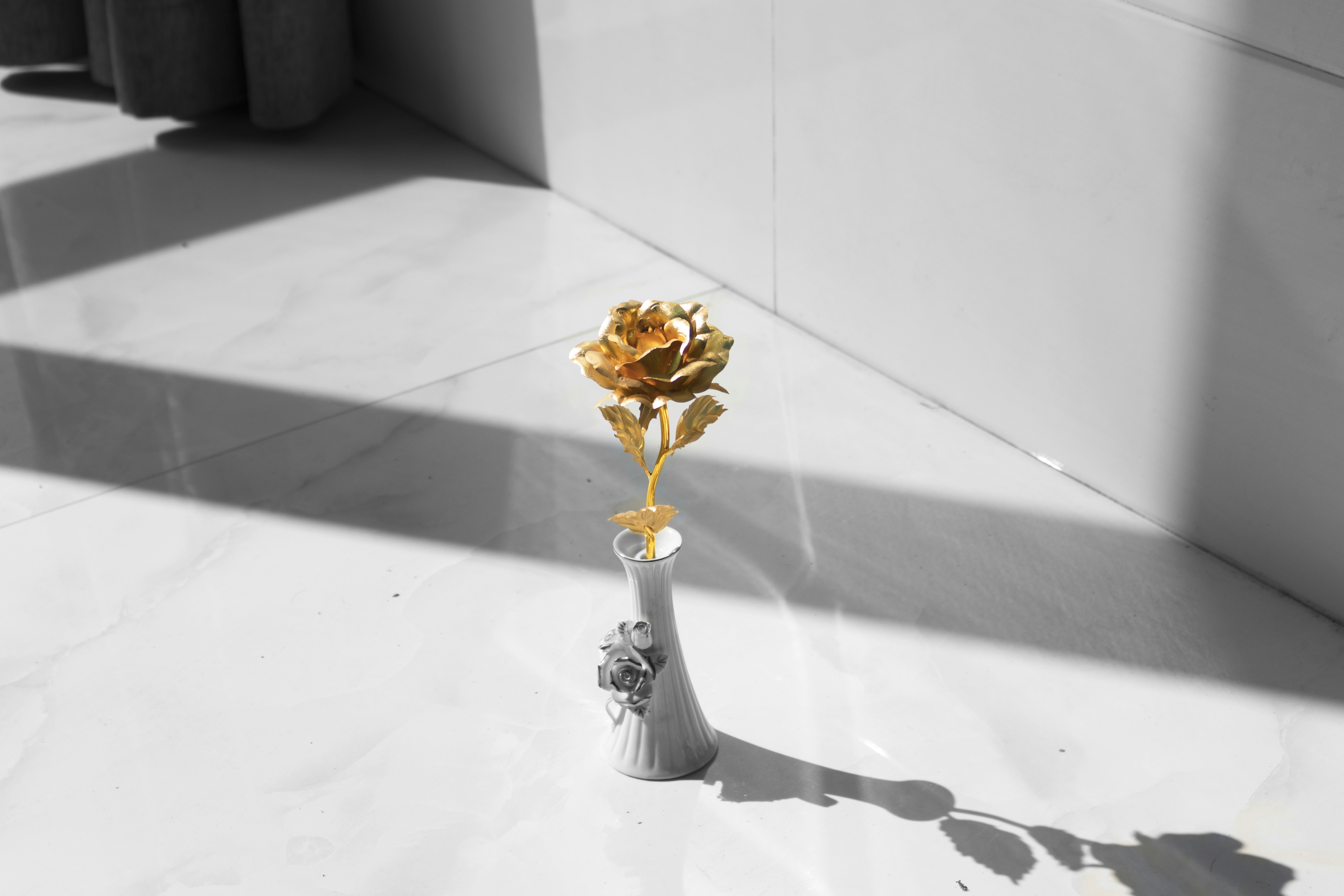 Gold rose in ceramic vase