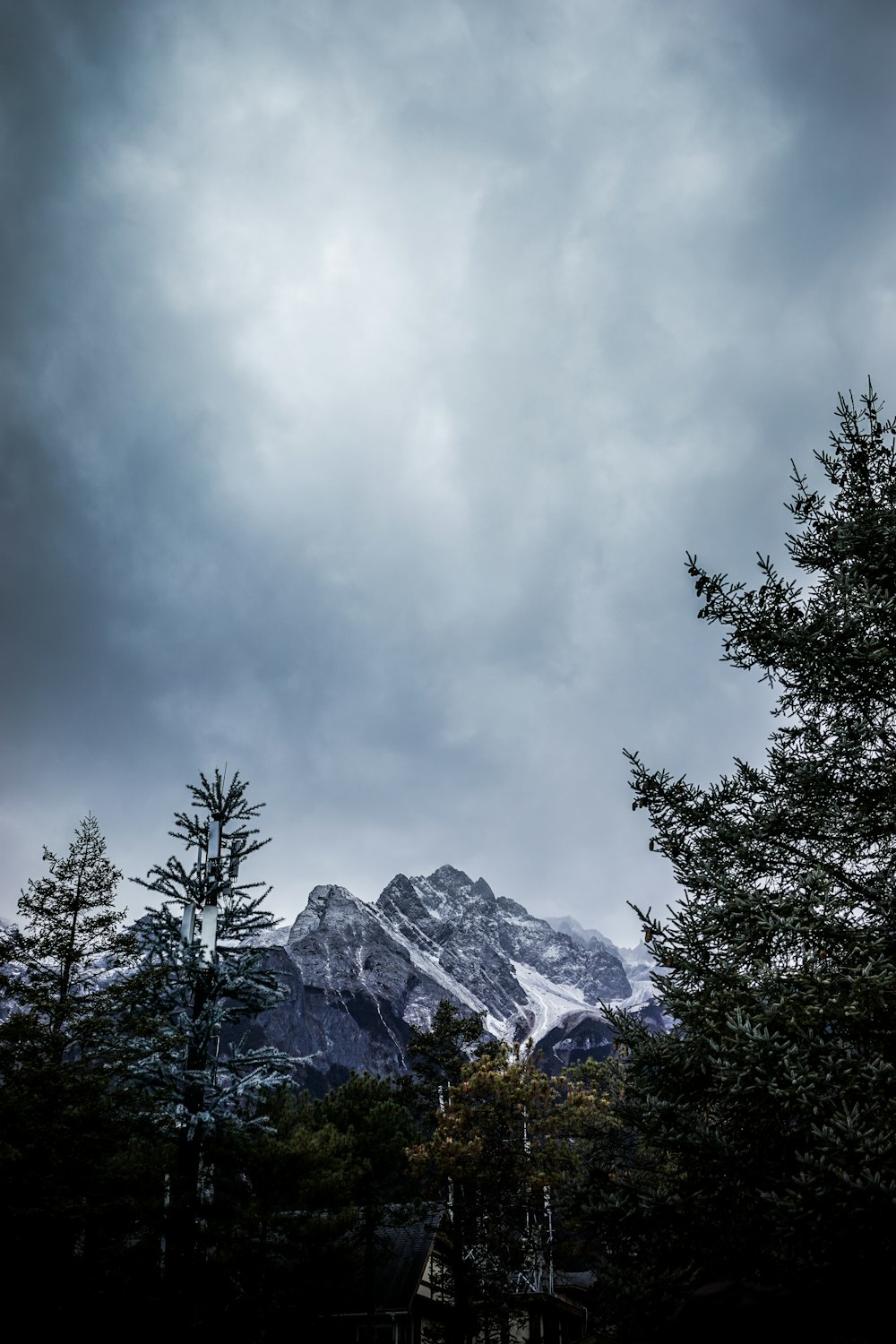 snow covered mountain under gray sky at daytime