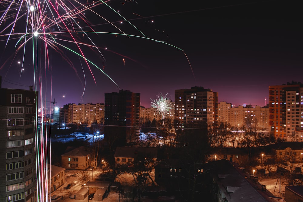 fireworks over gray concrete buildings