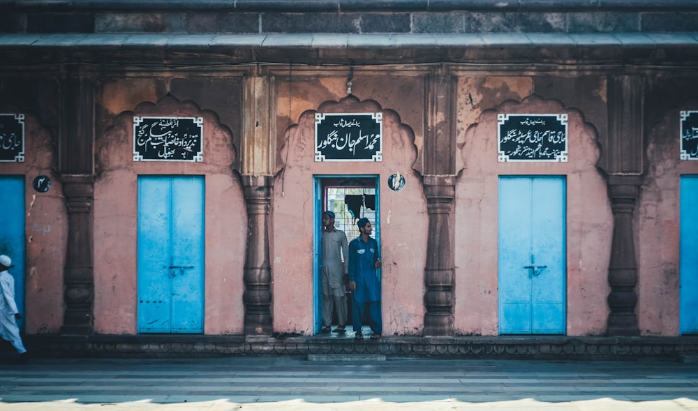 two men standing at middle of door