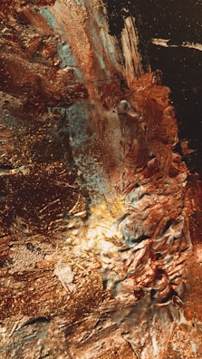 Detail of textured mixed-media artwork with copper accents.