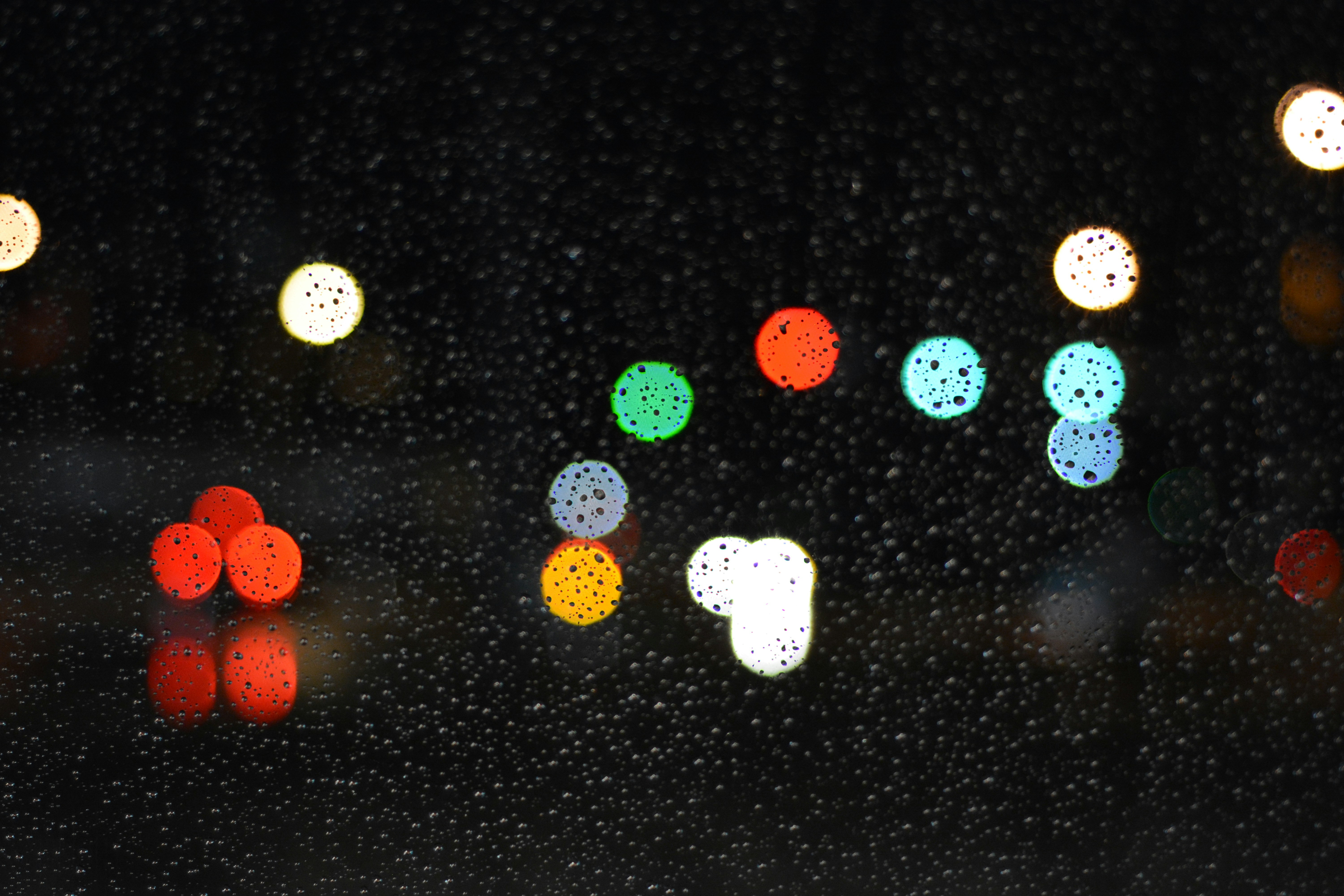 Vidrio con gotas de agua y luces bokeh