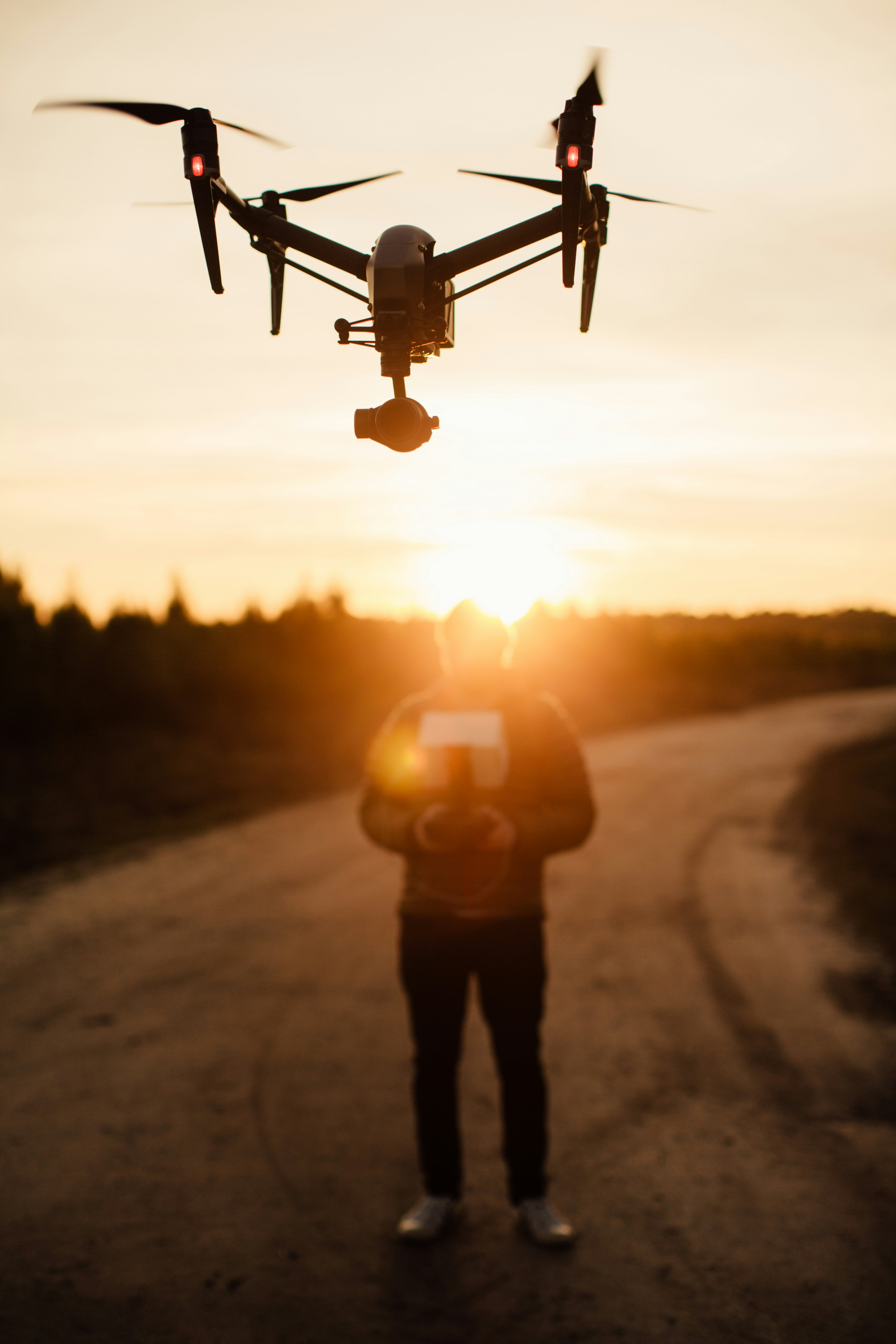 person facing drone during golden hour