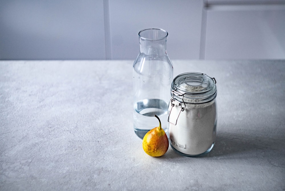 clear glass canister beside clear glass pitcher