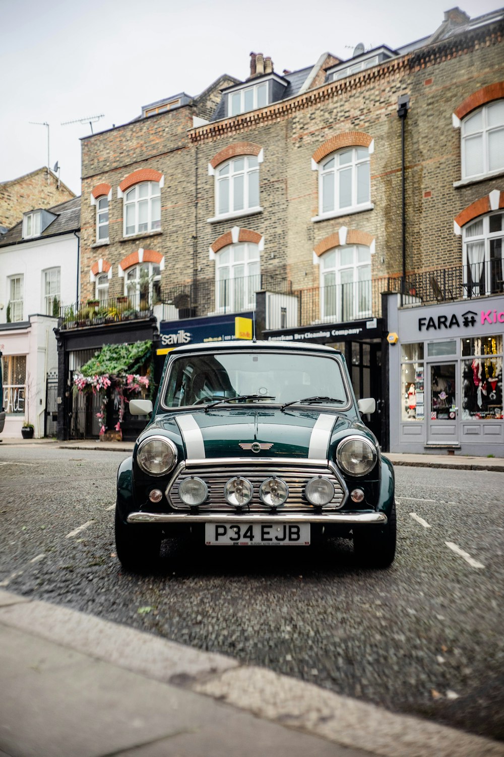 green Mini Cooper on road during daytime