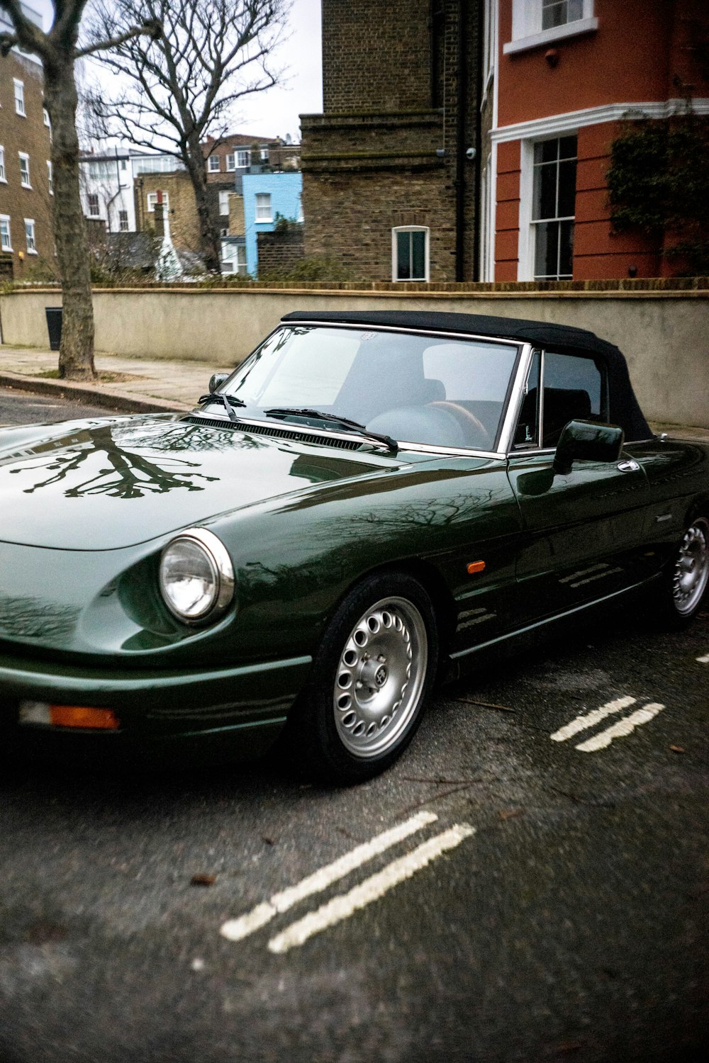 parked green convertible coupe