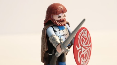 man with long beard while holding sword and shield minifig