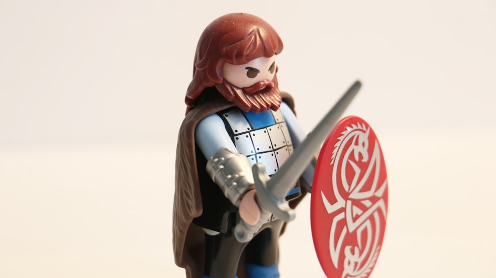man with long beard while holding sword and shield minifig