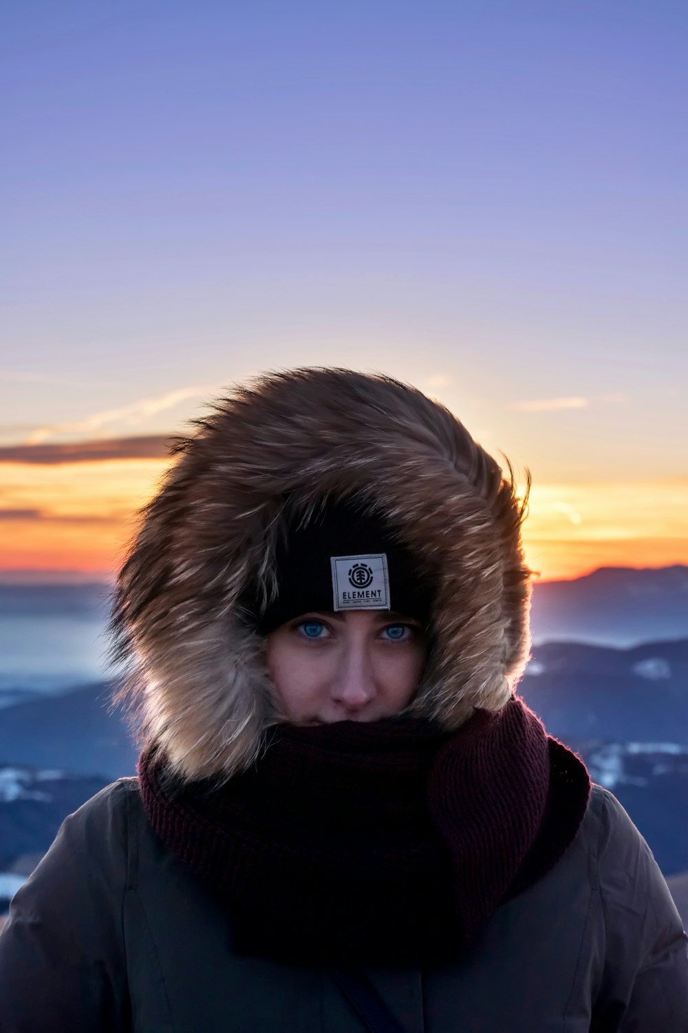 woman wearing grey and brown parka jacket