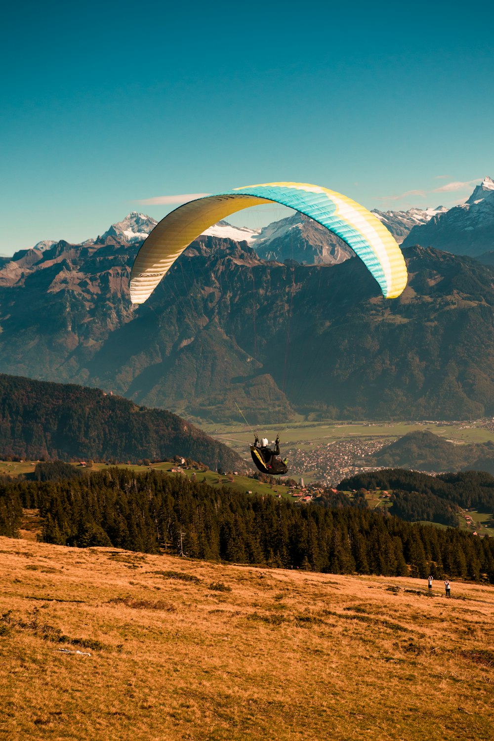 person riding parachute during daytime