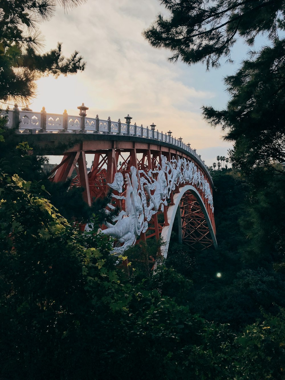 photo of orange and white metal bridge during sunrise