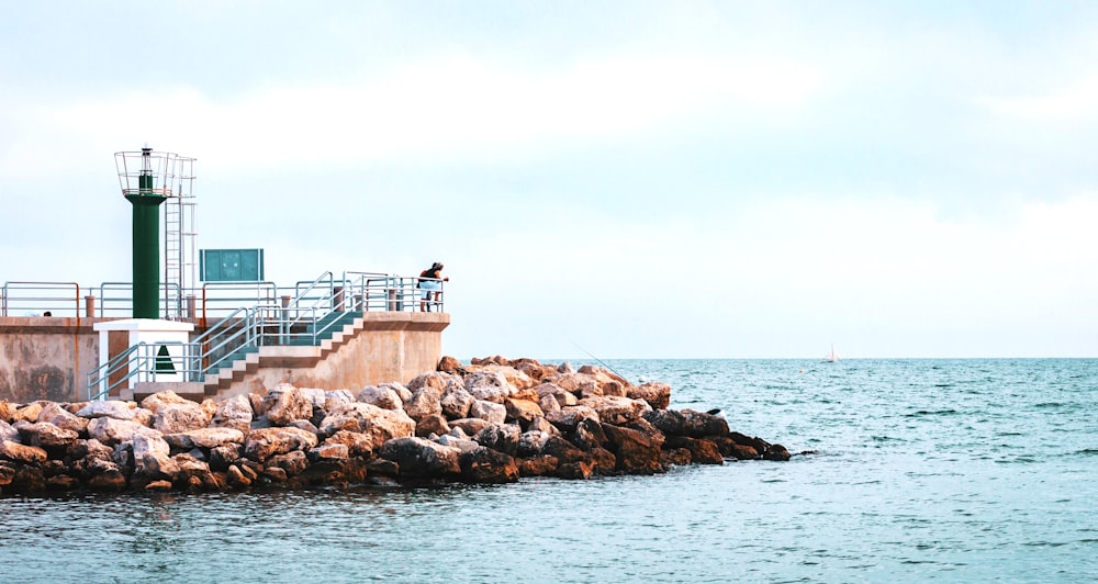 gray rocks and sea during daytime