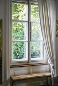 Elegant waterfall bench installed beneath a large window with soft natural light.