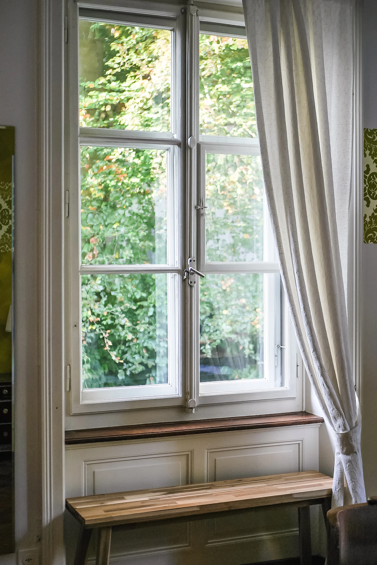 Elegant floor-length curtain panels in a bright room showing how properly weighted drapery hangs straight and even
