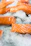 Close-up of a vibrant, fresh salmon fillet on crushed ice at a market stall.