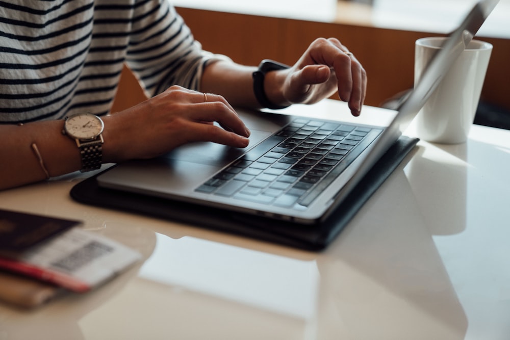 person seated at the table using laptop